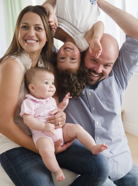 Mother and father playing with daughters