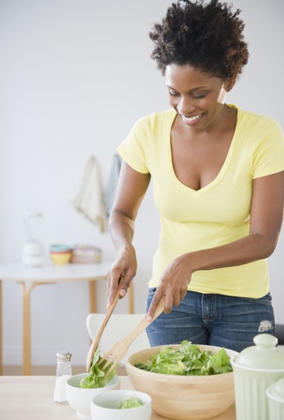 Black woman serving salad
