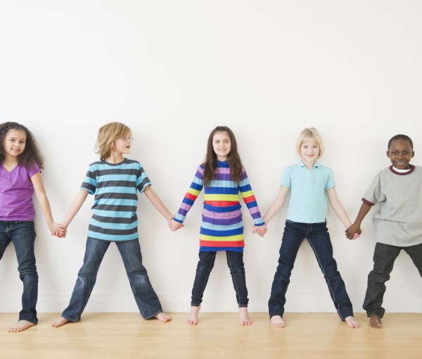 Friends holding hands in a row