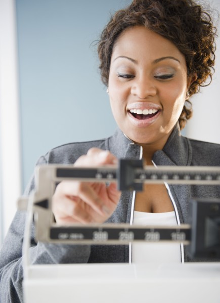 African American woman weighing herself
