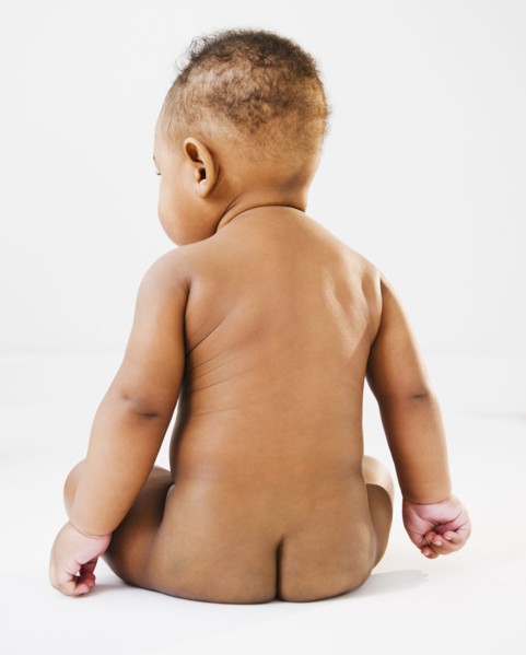 Nude Black baby sitting on floor