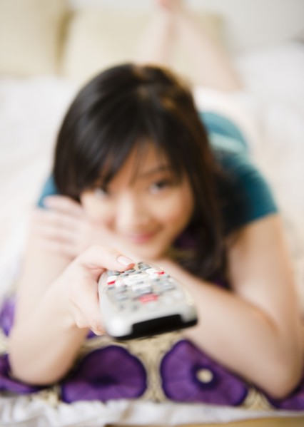 Korean woman holding remote control