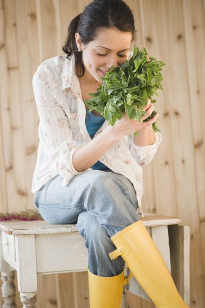Brazilian woman smelling fresh mint