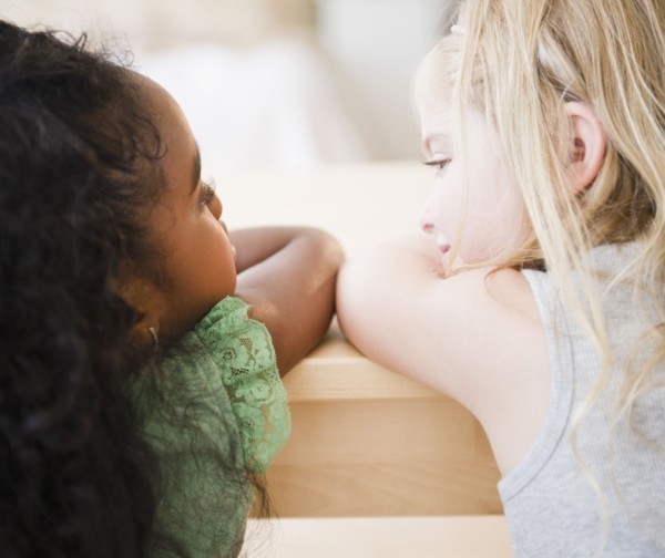 Girls leaning on table together