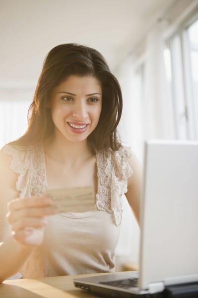 Mixed race woman shopping online with credit card