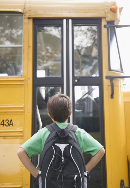 Caucasian boy waiting for school bus