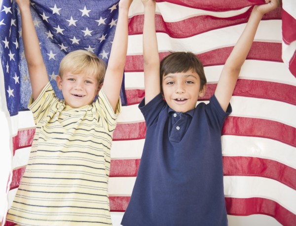 Boys holding American flag together