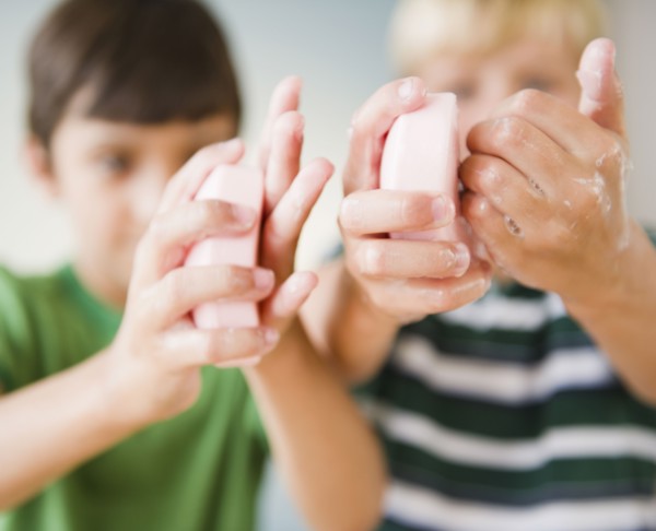 Boys washing their hands with soap