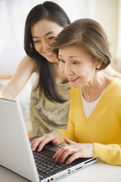 Japanese mother and daughter using laptop together