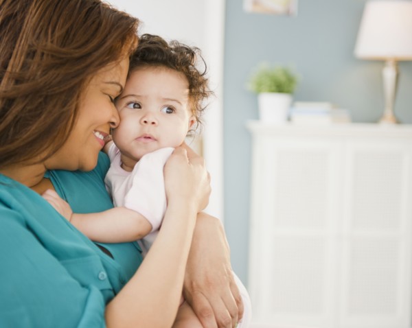 Mixed race mother snuggling baby