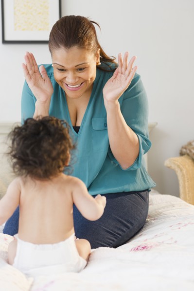Mixed race mother playing with baby