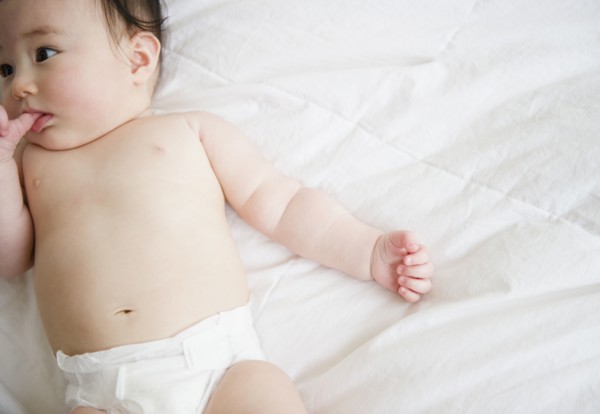 Asian baby girl laying on blanket