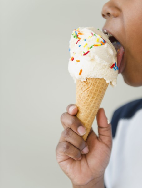 Black boy licking ice cream cone