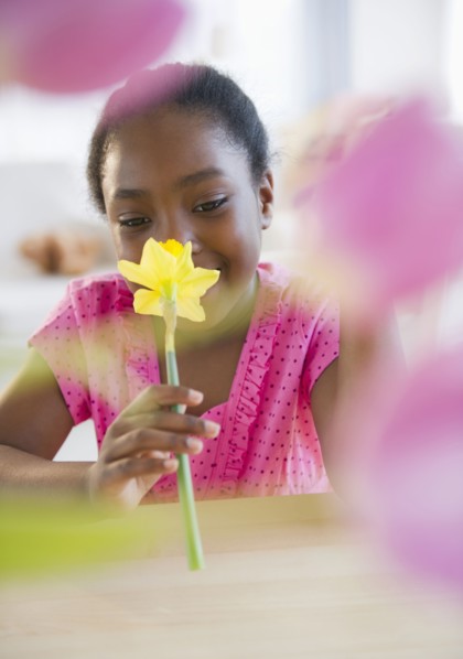 Black girl smelling flower