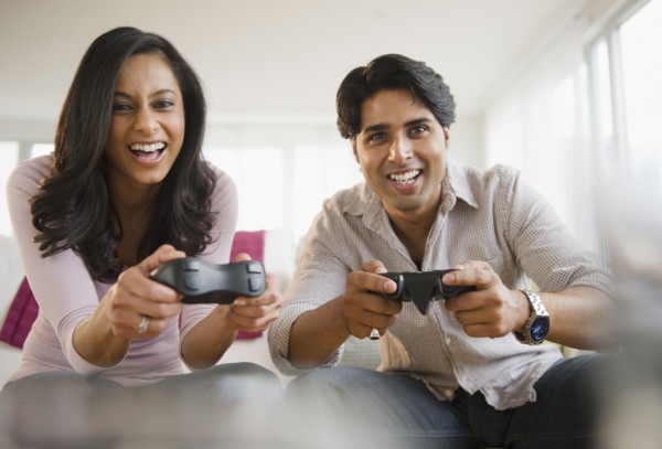 Mixed race couple playing video game