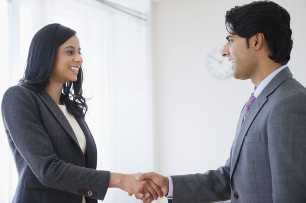 Mixed race business people shaking hands