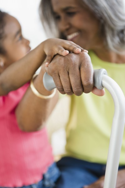 African American girl holding hands with grandmother