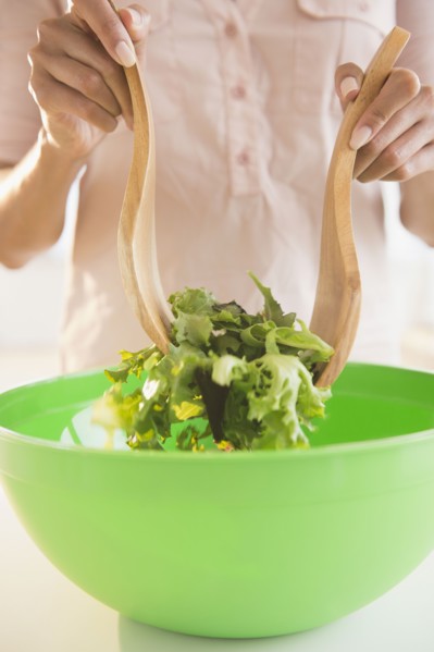 Cape Verdean woman tossing a salad