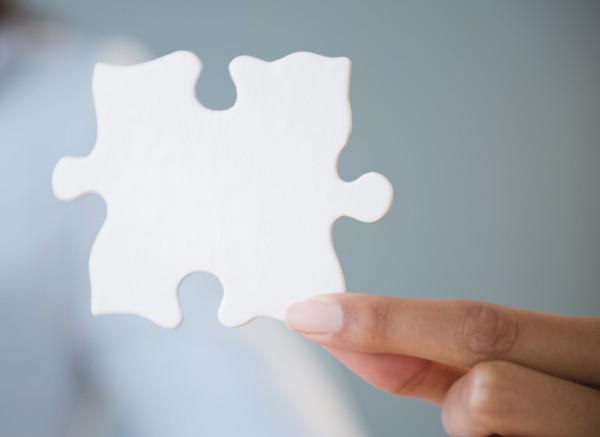Cape Verdean woman holding puzzle piece