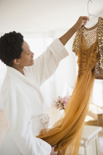 African American woman holding up glamorous dress