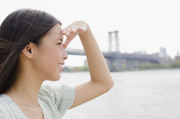 Asian woman looking at urban cityscape