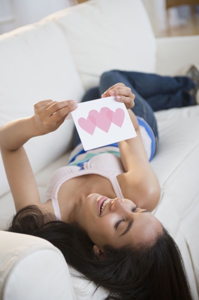 Hispanic teenager reading Valentine's Day card