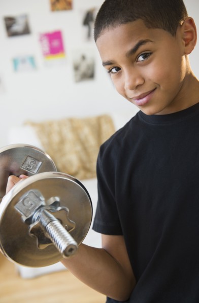 Hispanic boy lifting weights