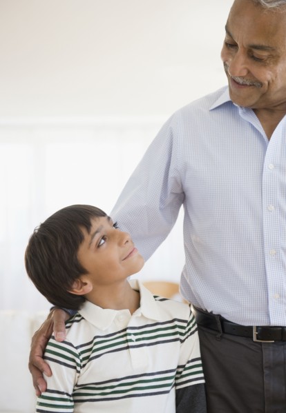 Hispanic grandfather smiling at grandson