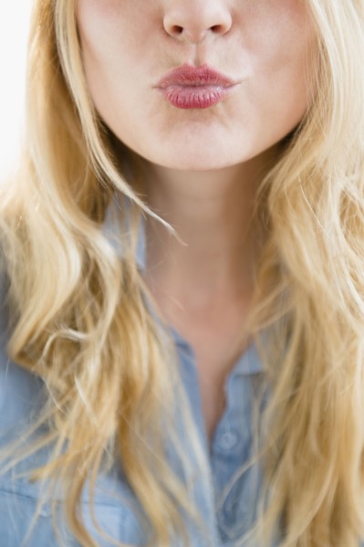 Caucasian woman blowing a kiss