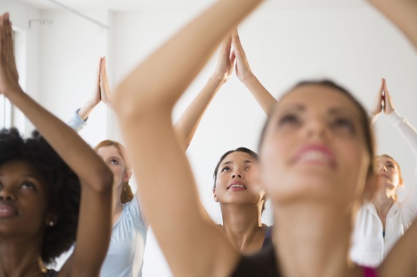 Women practicing yoga in class