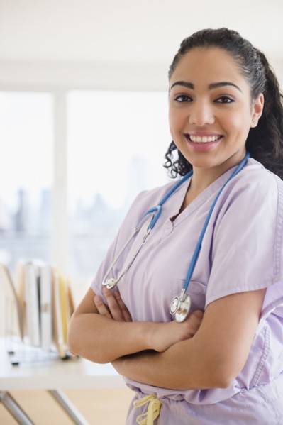 Hispanic nurse smiling in hospital