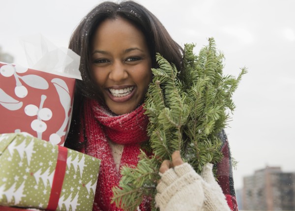 African American woman carrying Christmas presents