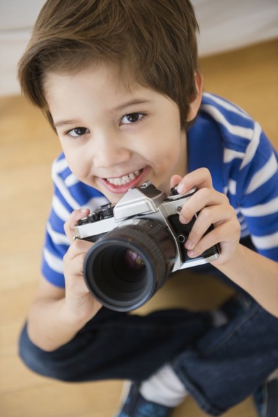 Hispanic boy taking pictures