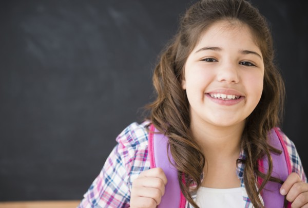 Hispanic girl smiling in classroom