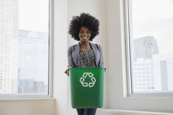 Mixed race businesswoman with recycling bin