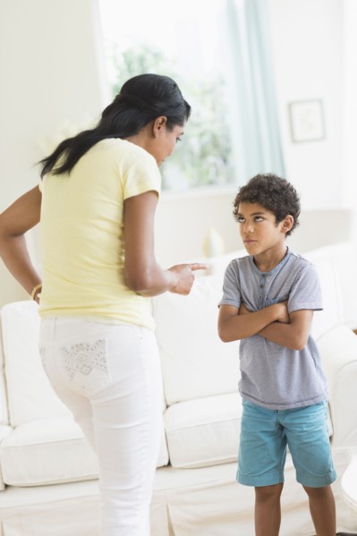 Mother scolding son in living room