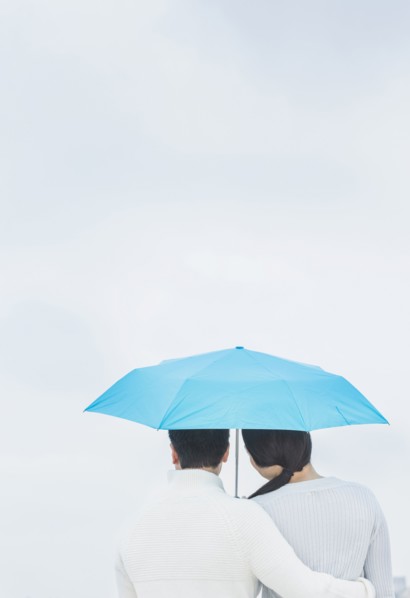 Couple hugging under umbrella