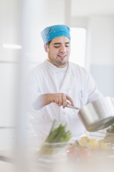 Mixed race chef cooking in restaurant
