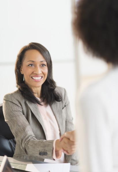 African American businesswomen shaking hands