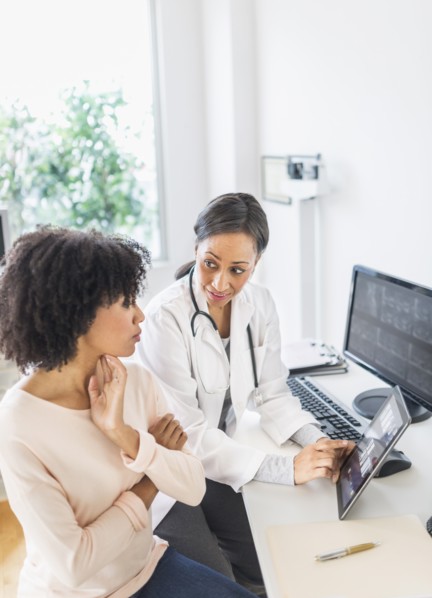 African American doctor and patient talking in office