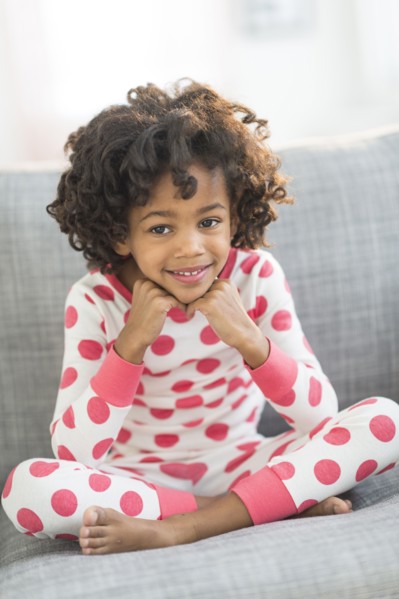 Portrait of smiling African American girl in pajamas