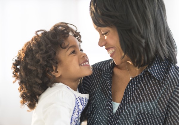 African American mother and daughter hugging and smiling