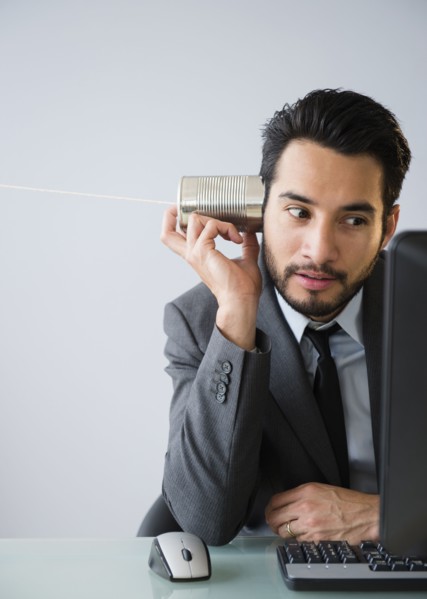 Mixed race businessman using tin can telephone
