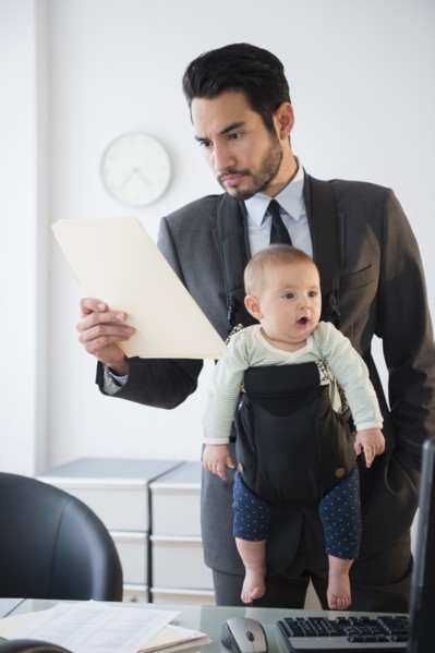 Businessman working with baby in office