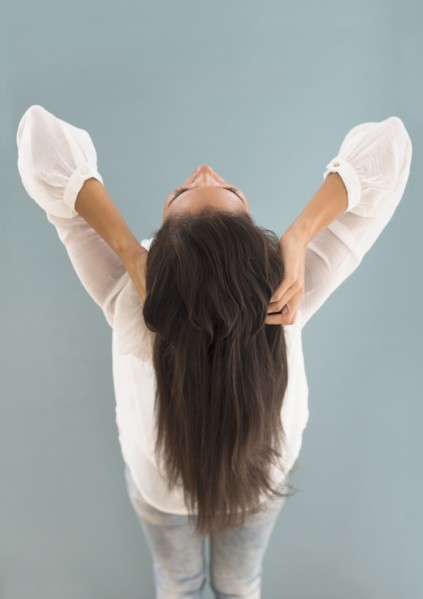 Hispanic woman with long hair leaning back