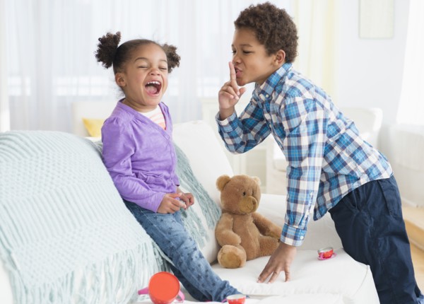 Black children playing on sofa