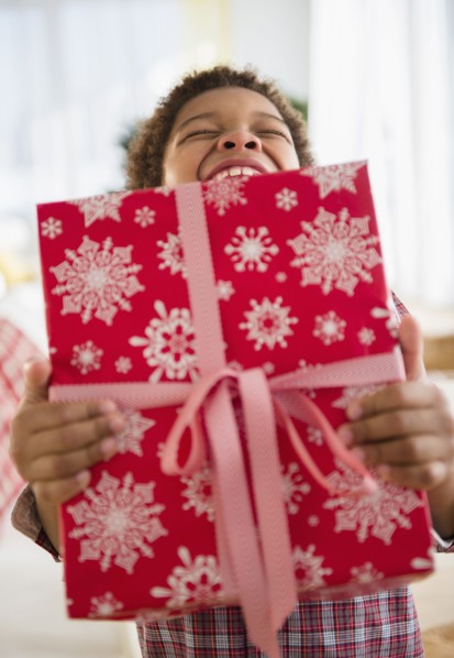 Black boy holding Christmas present
