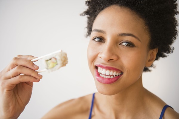 Black woman eating sushi