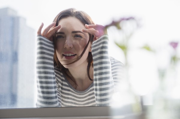 Woman peering in through window