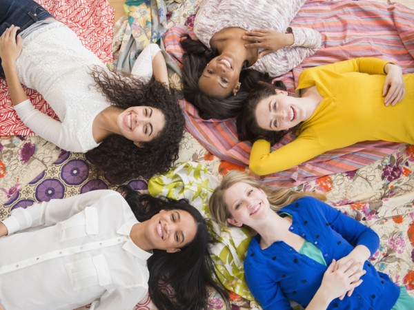 Women relaxing together on blankets